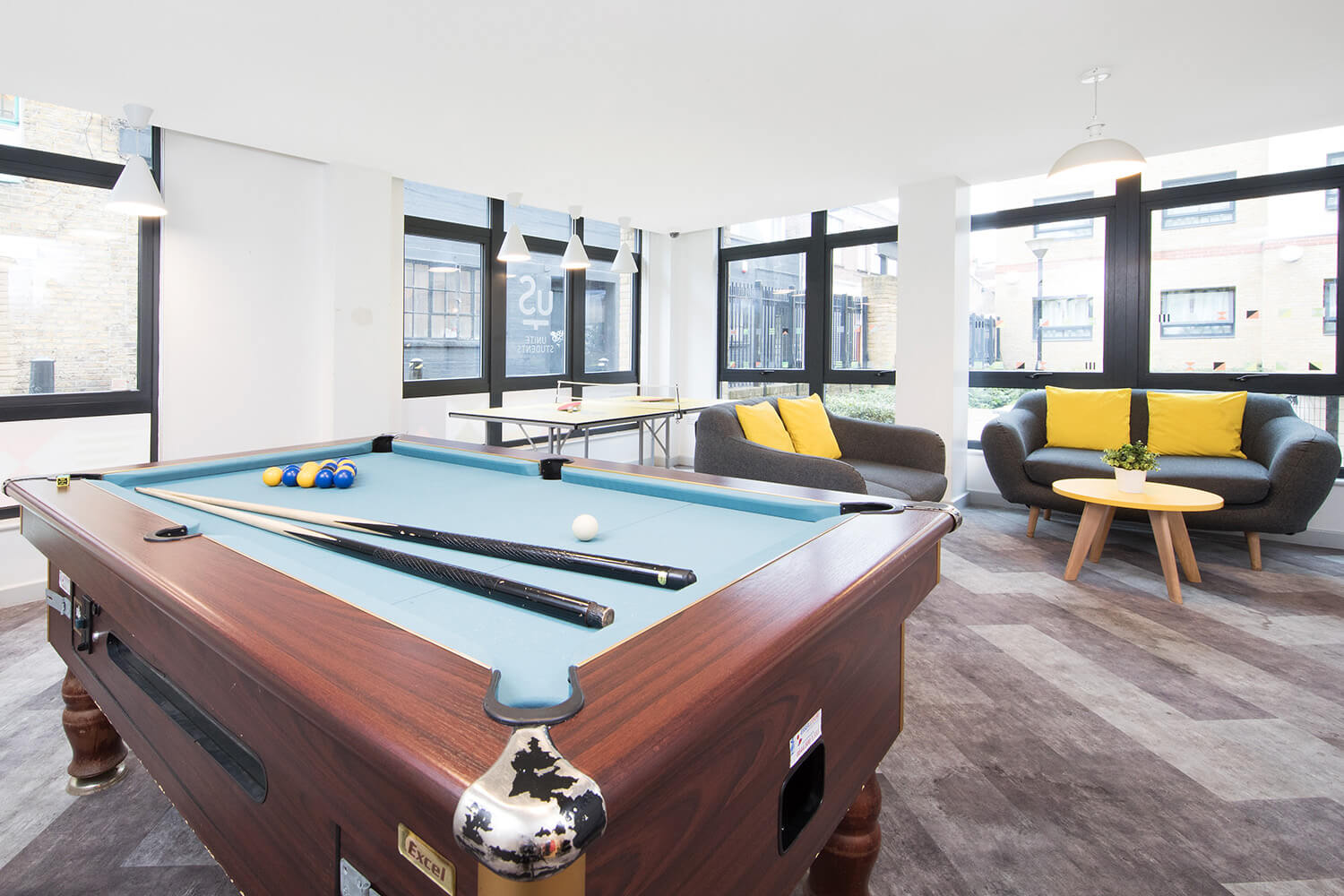 Student accommodation London pool table and sofas in common room at Pacific Court