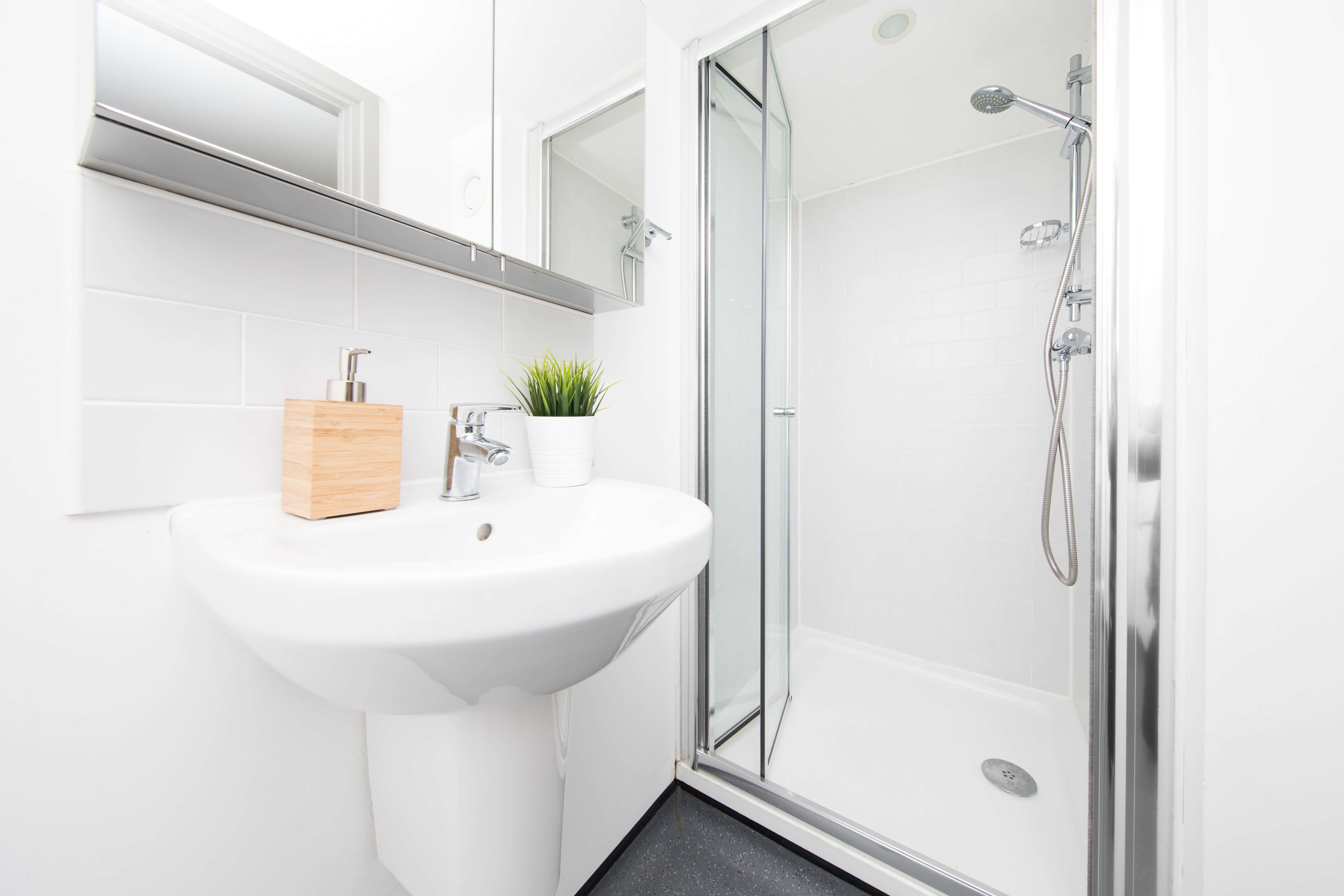 Sink and shower cubicle in studio bathroom