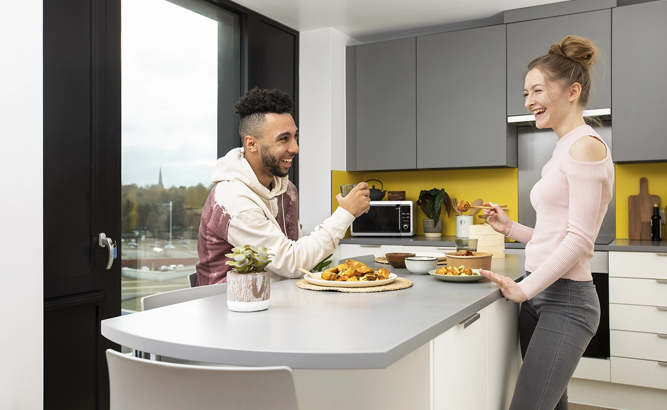 Students using the shared kitchen for ensuite rooms