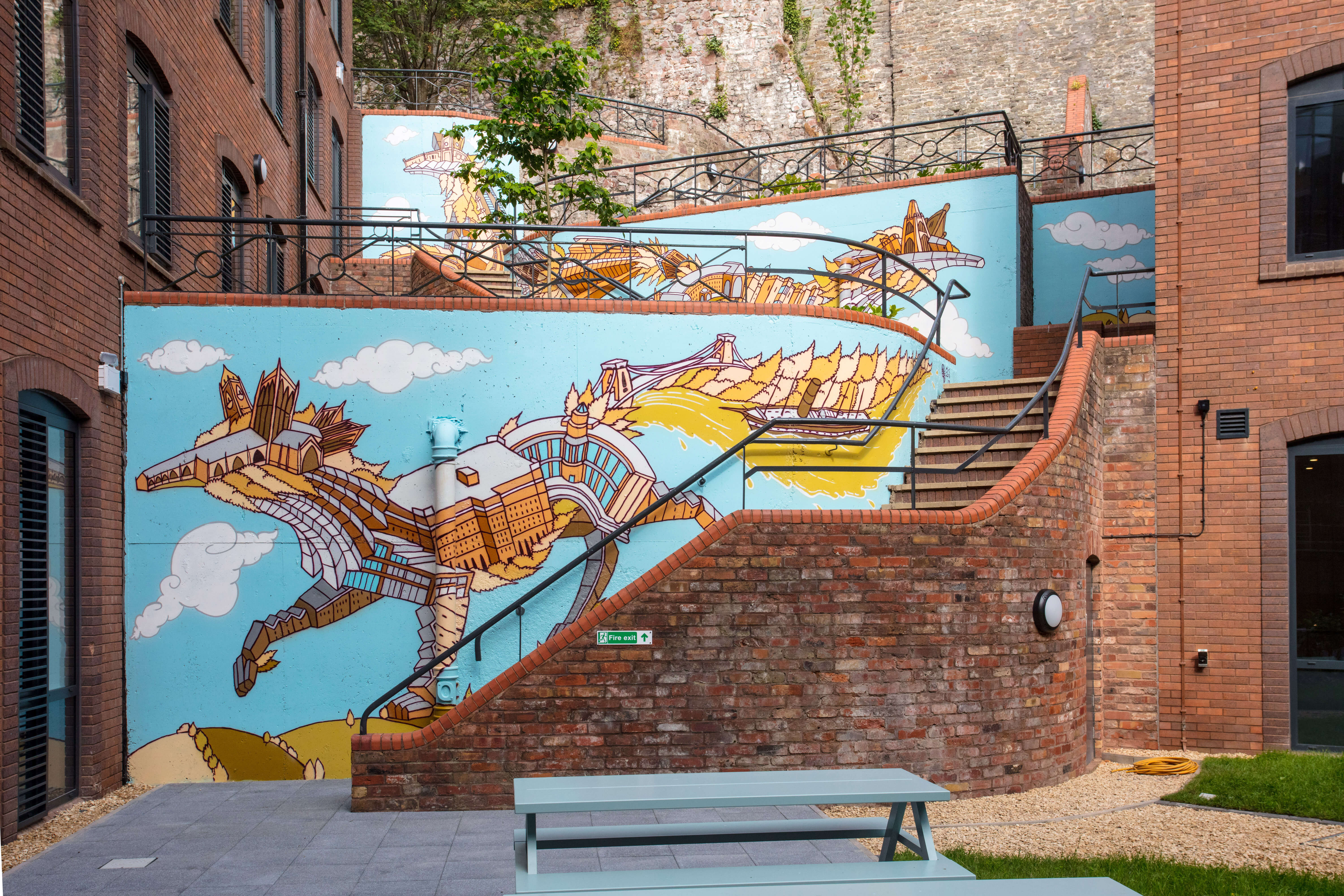 Artwork on a wall by steps outside
