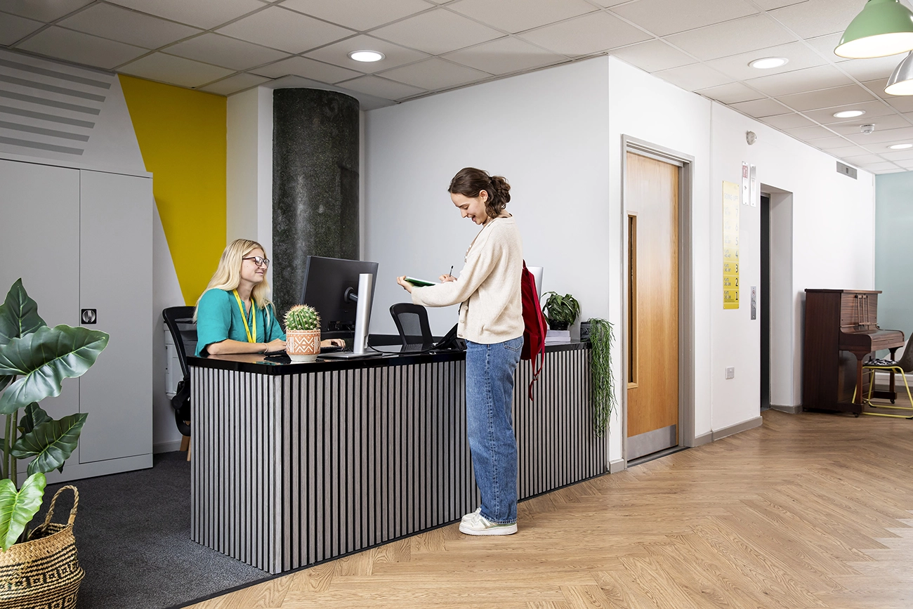 Student and staff member at reception