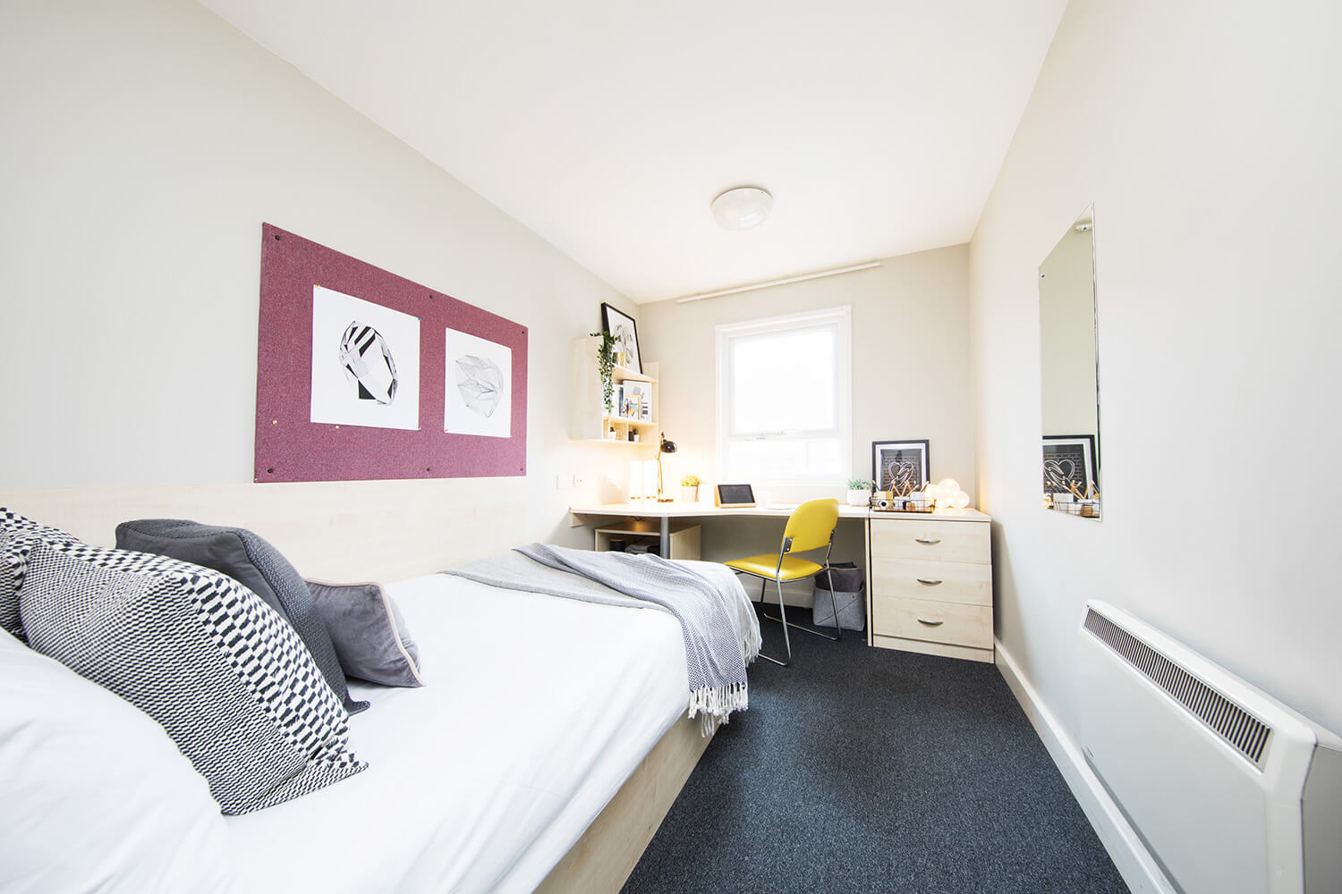 Bed and study space in an en-suite room at Raglan House student accommodation in Coventry