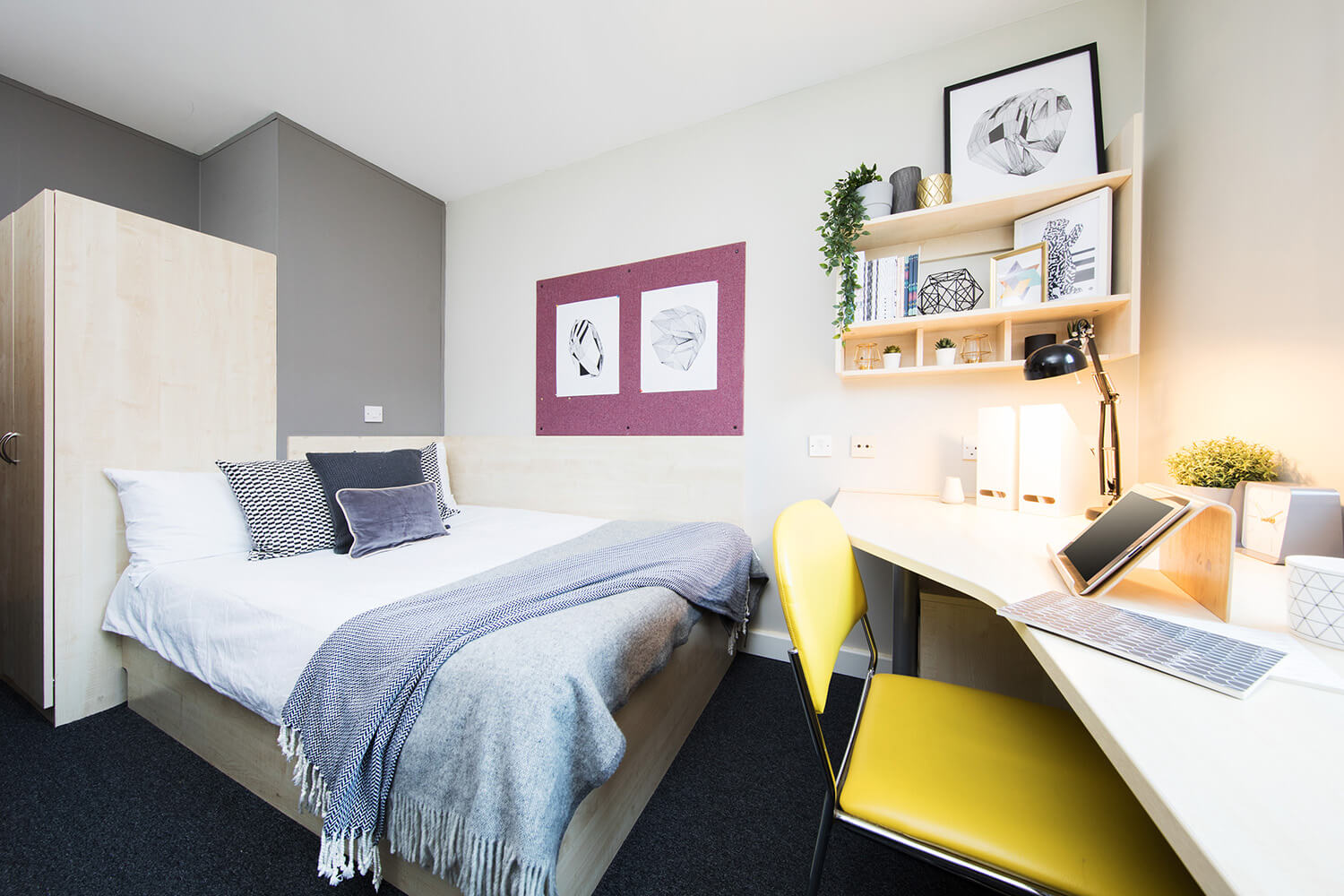 Bed and study space in an en-suite room at Raglan House student accommodation in Coventry