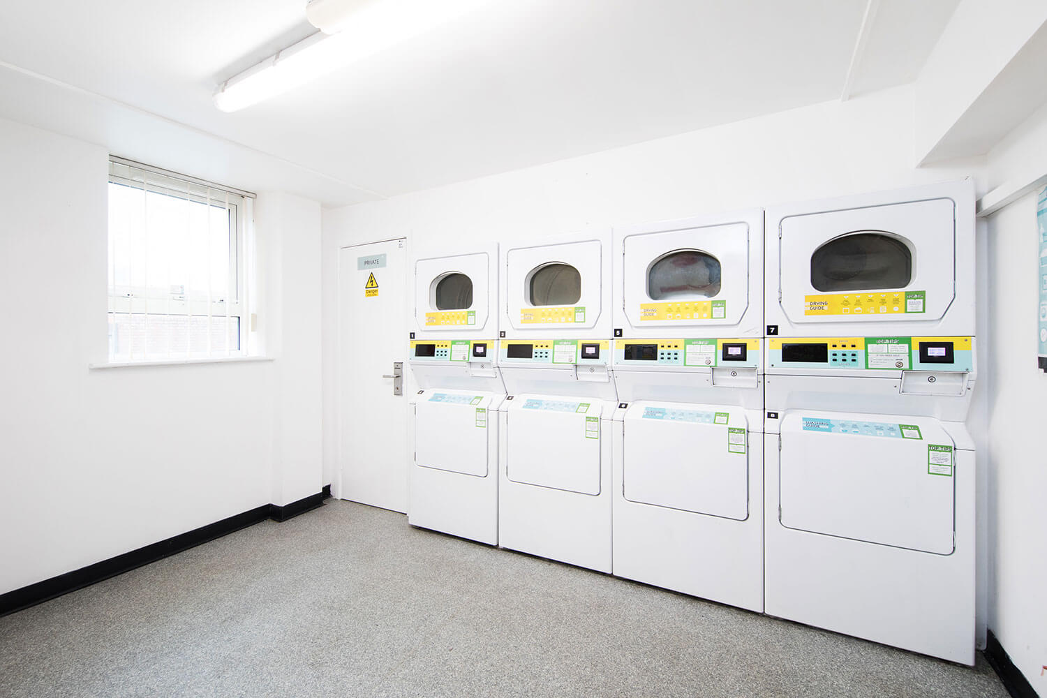 Laundry room with washing machines at Raglan House student accommodation in Coventry