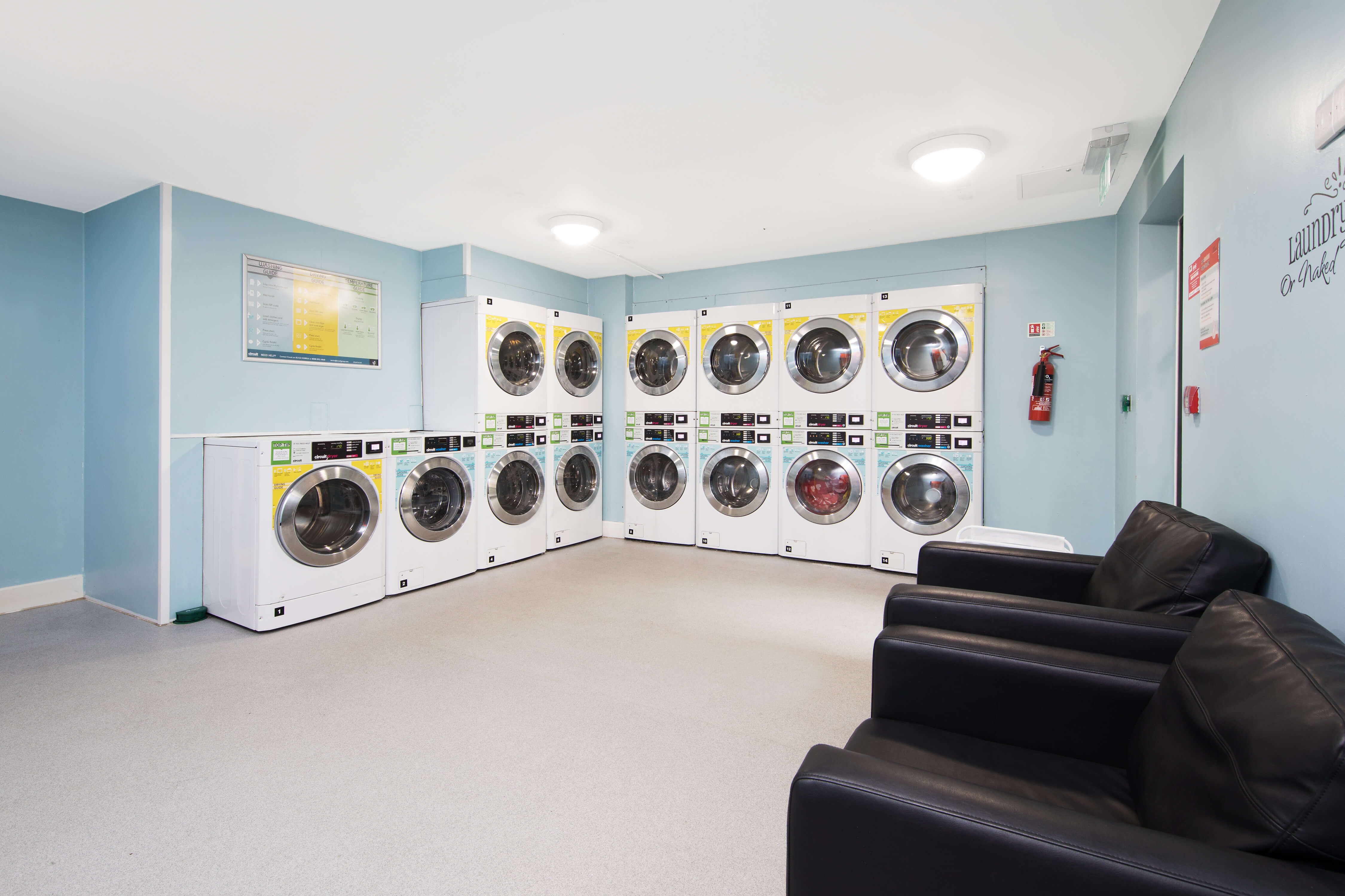 Laundry machines and sofa at Kelvin Court