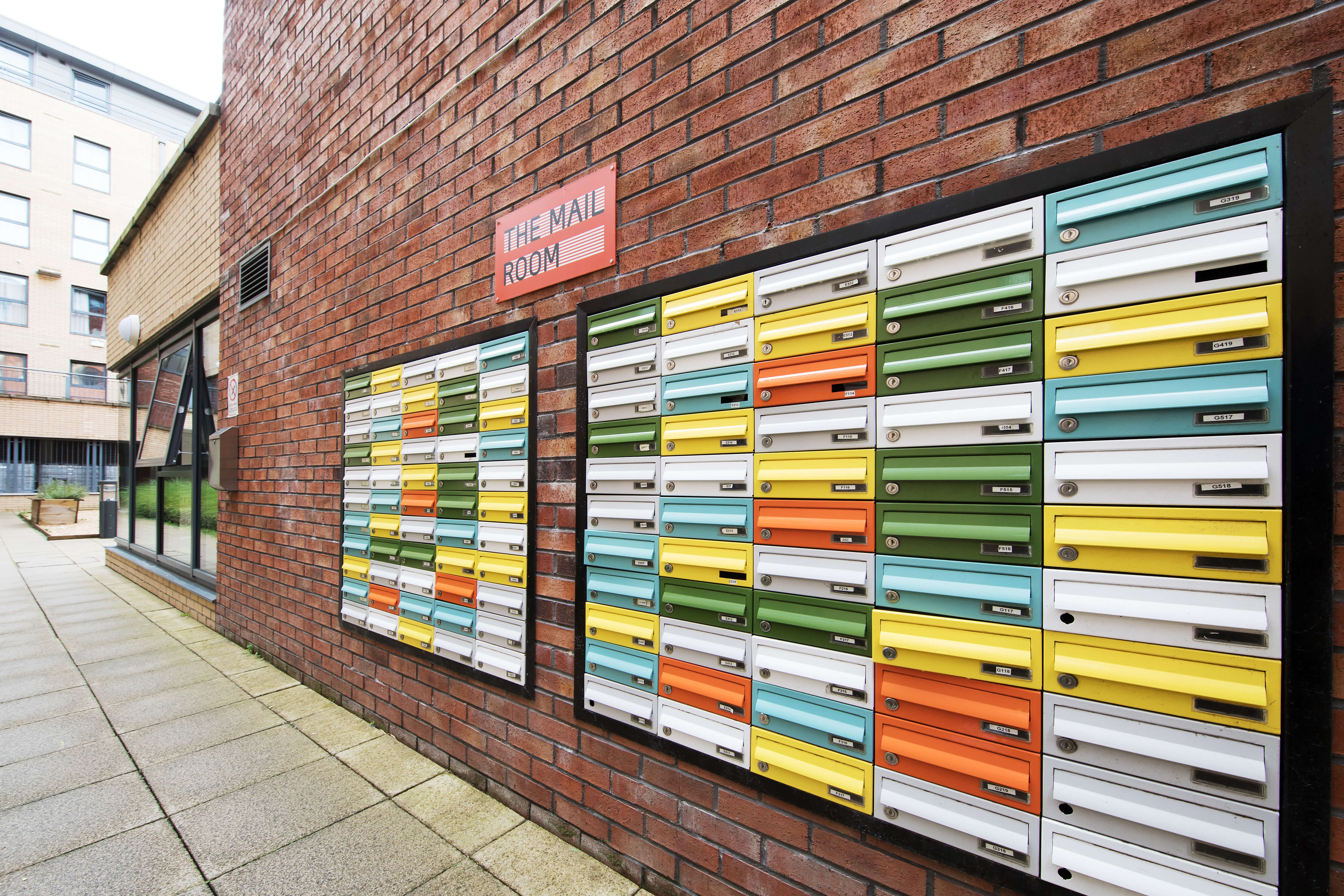 Colourful post boxes on the side of Kelvin Court