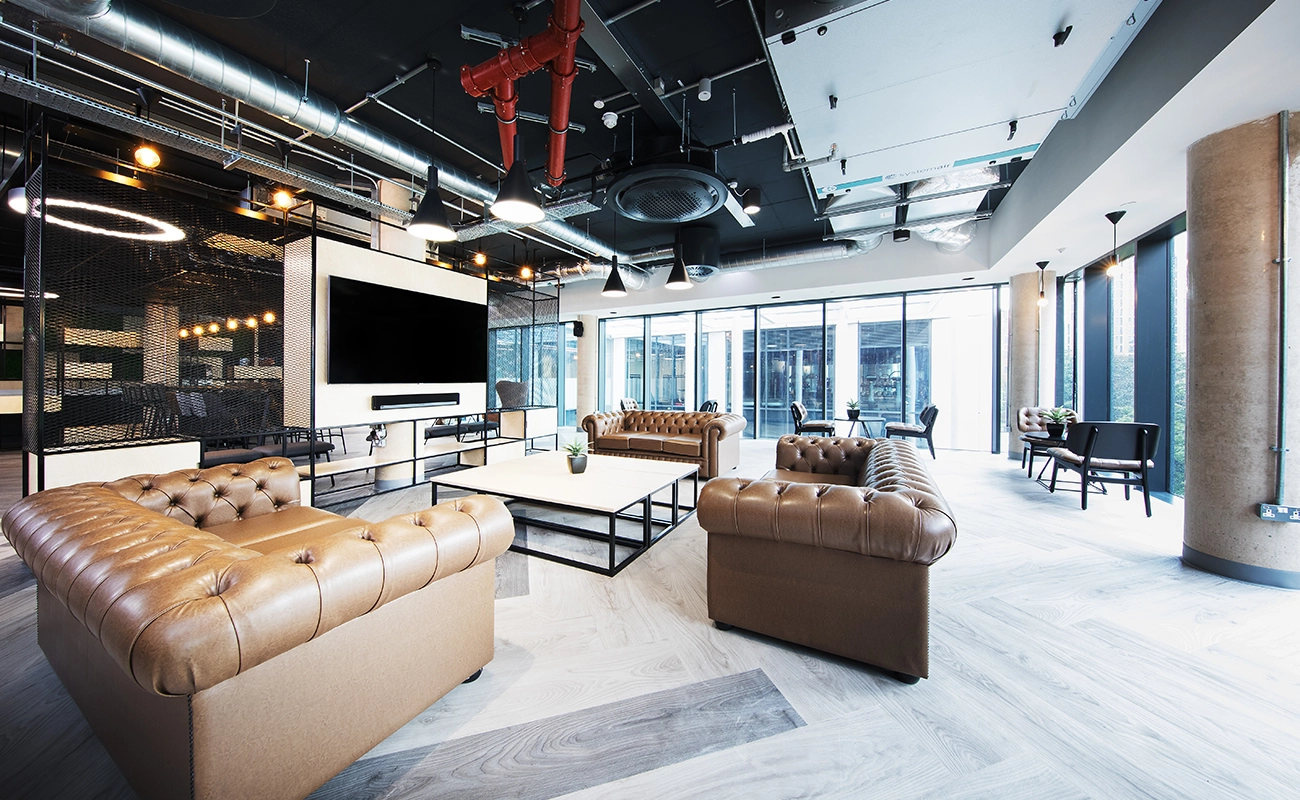 Common room seating area with sofa and TV