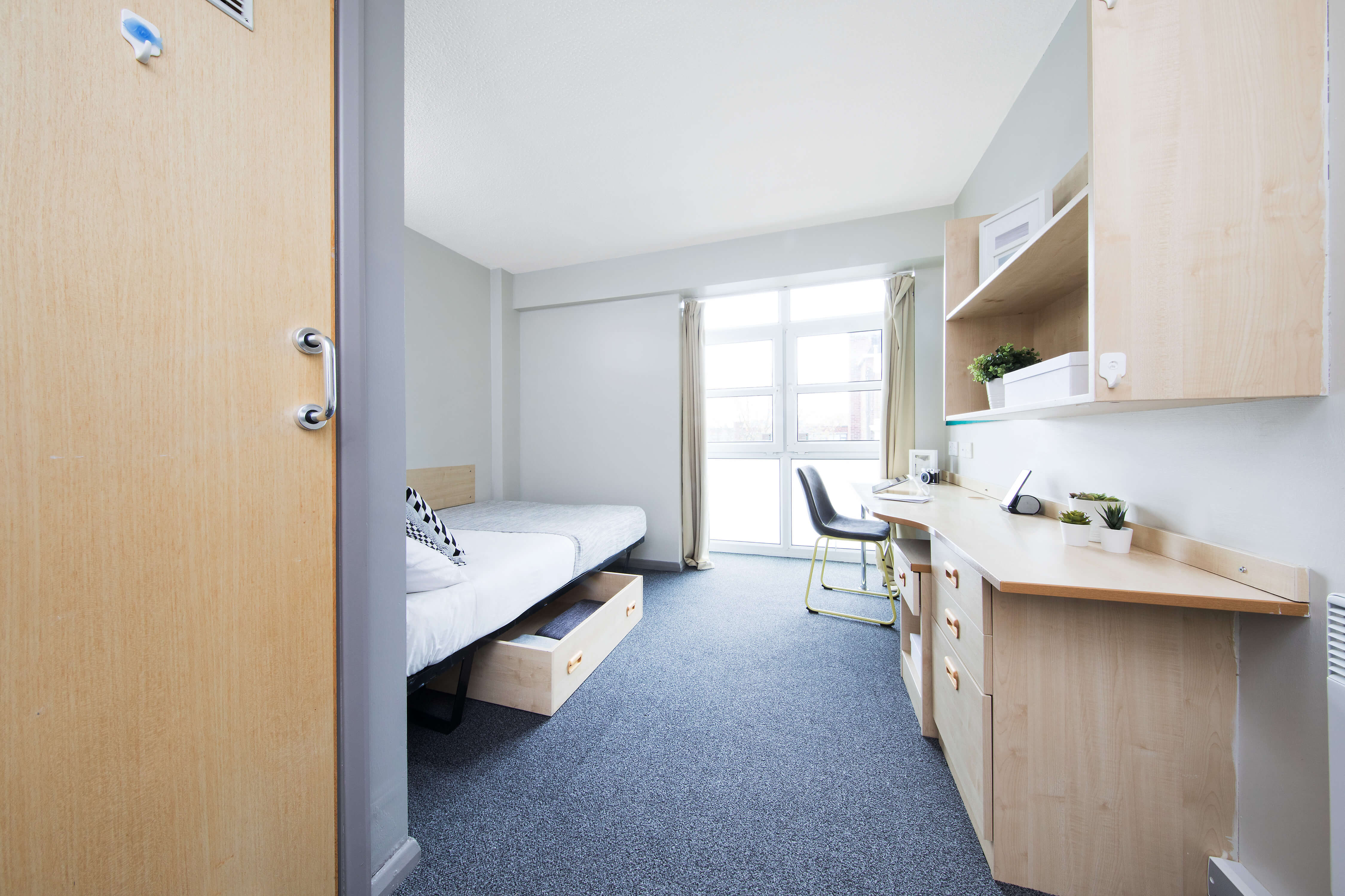 Bed and study space in en-suite room