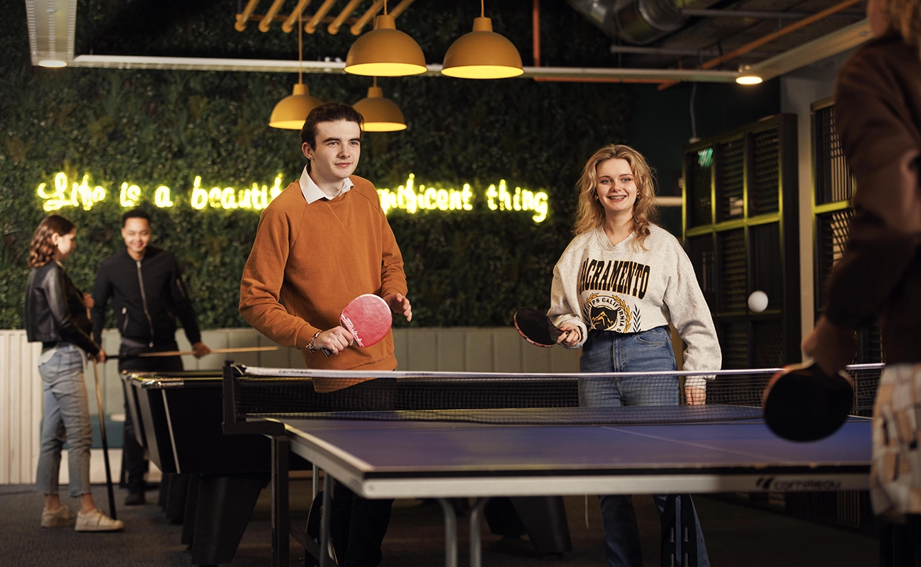 Students in the common room games area