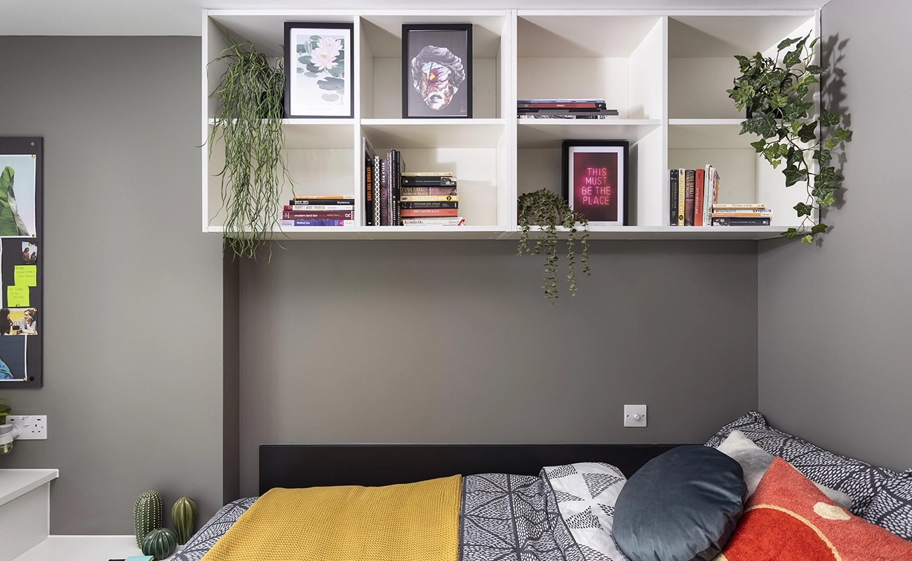 Bed in the ensuite rooms with overhead storage