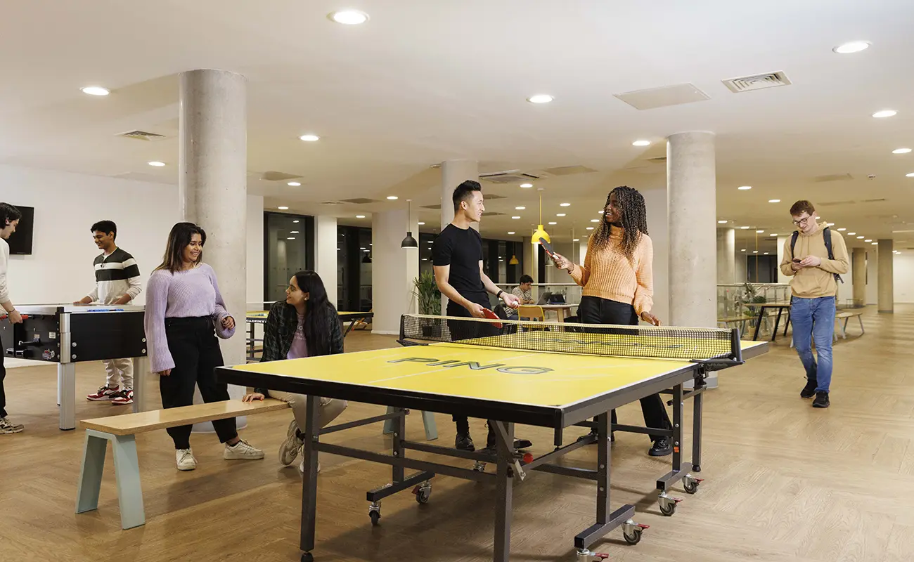 Students using the games area in the common room
