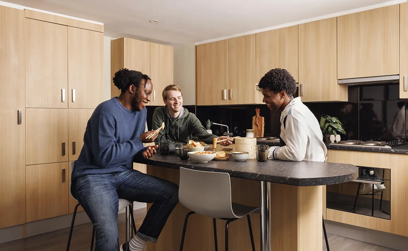 Students using the shared kitchen for ensuite rooms