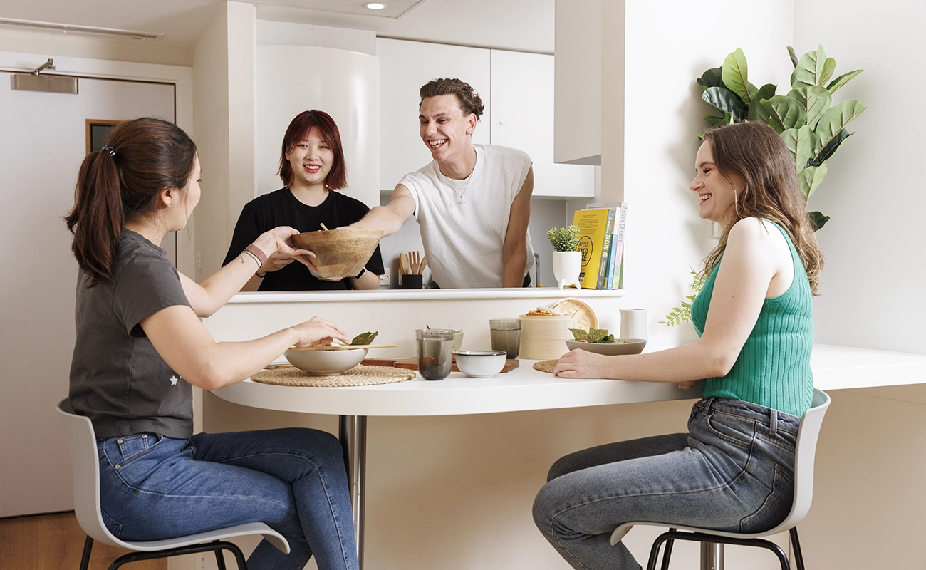 Students using the shared kitchen for ensuite rooms