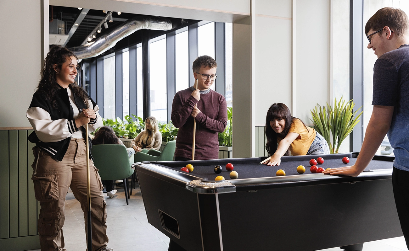 Students using the games area in the common room