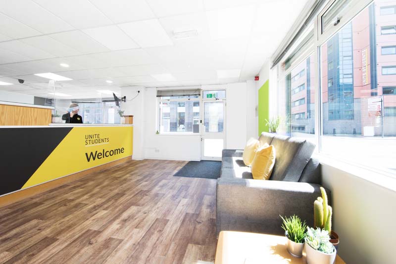 Reception seating area and desk at Rosamond House in Manchester, Unite Students accommodation