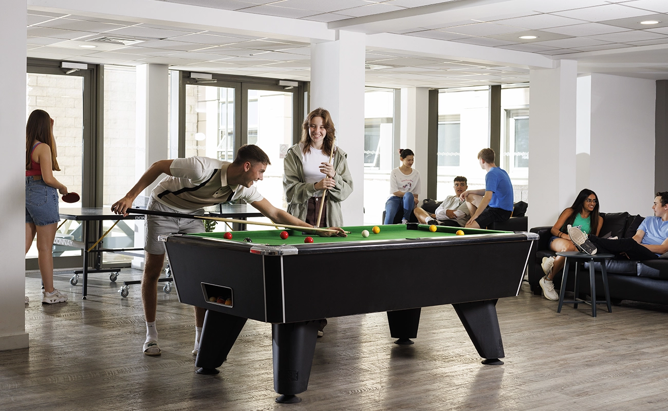 Students in the games area in the common room