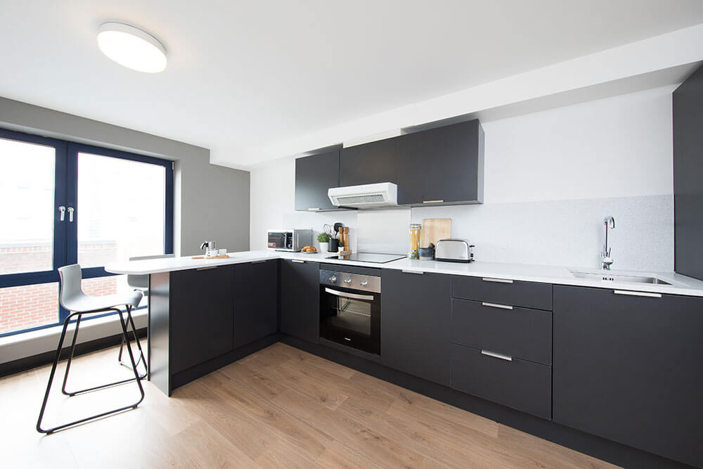 Shared kitchen cooking space and breakfast bar area