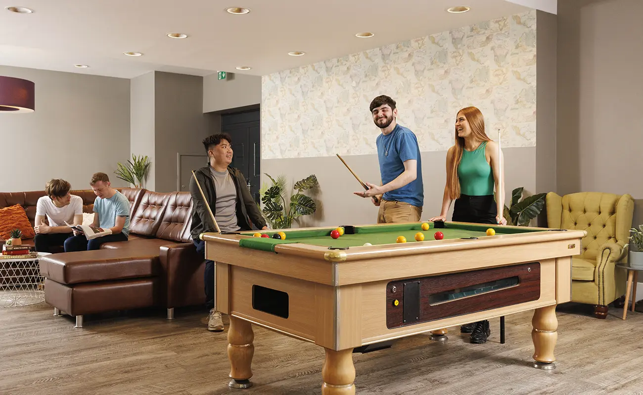 Students in game room at pool table