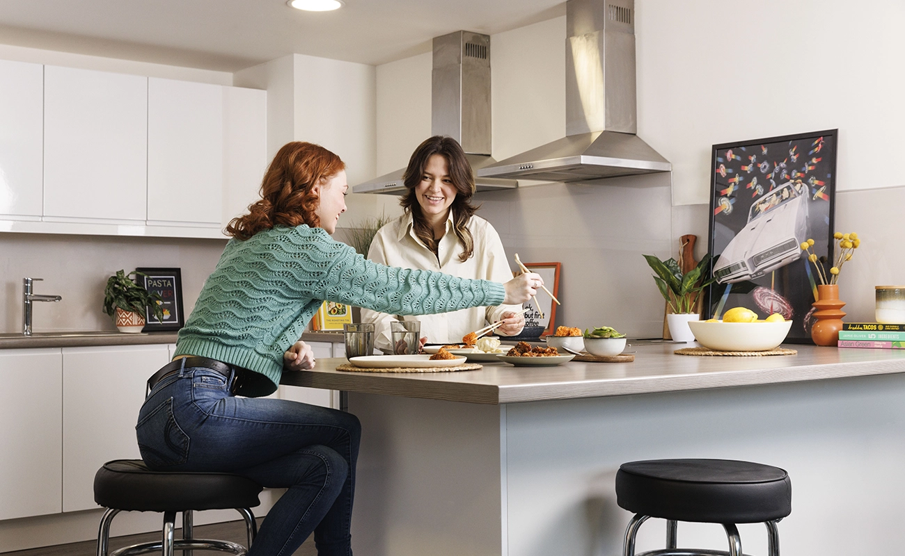 Students using the shared kitchen for ensuite rooms