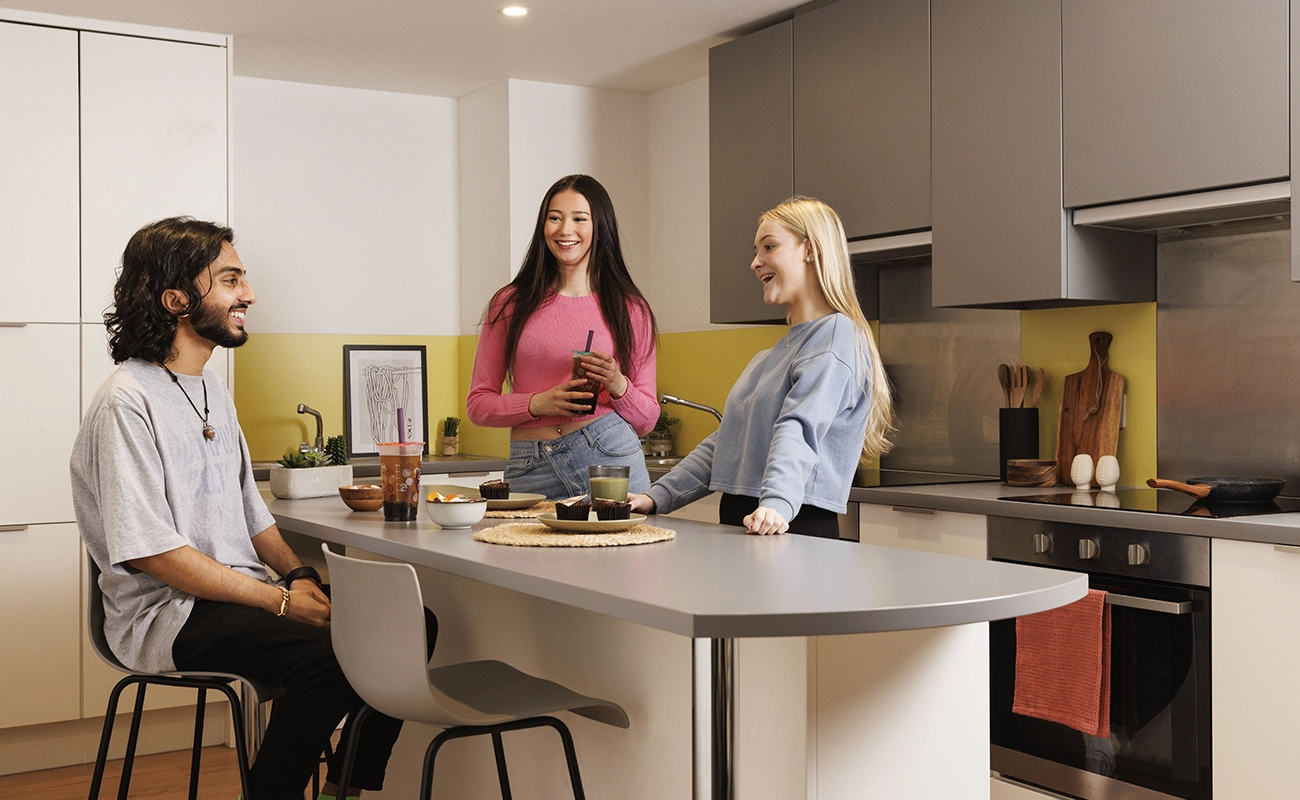 Students using the shared kitchen for ensuite rooms