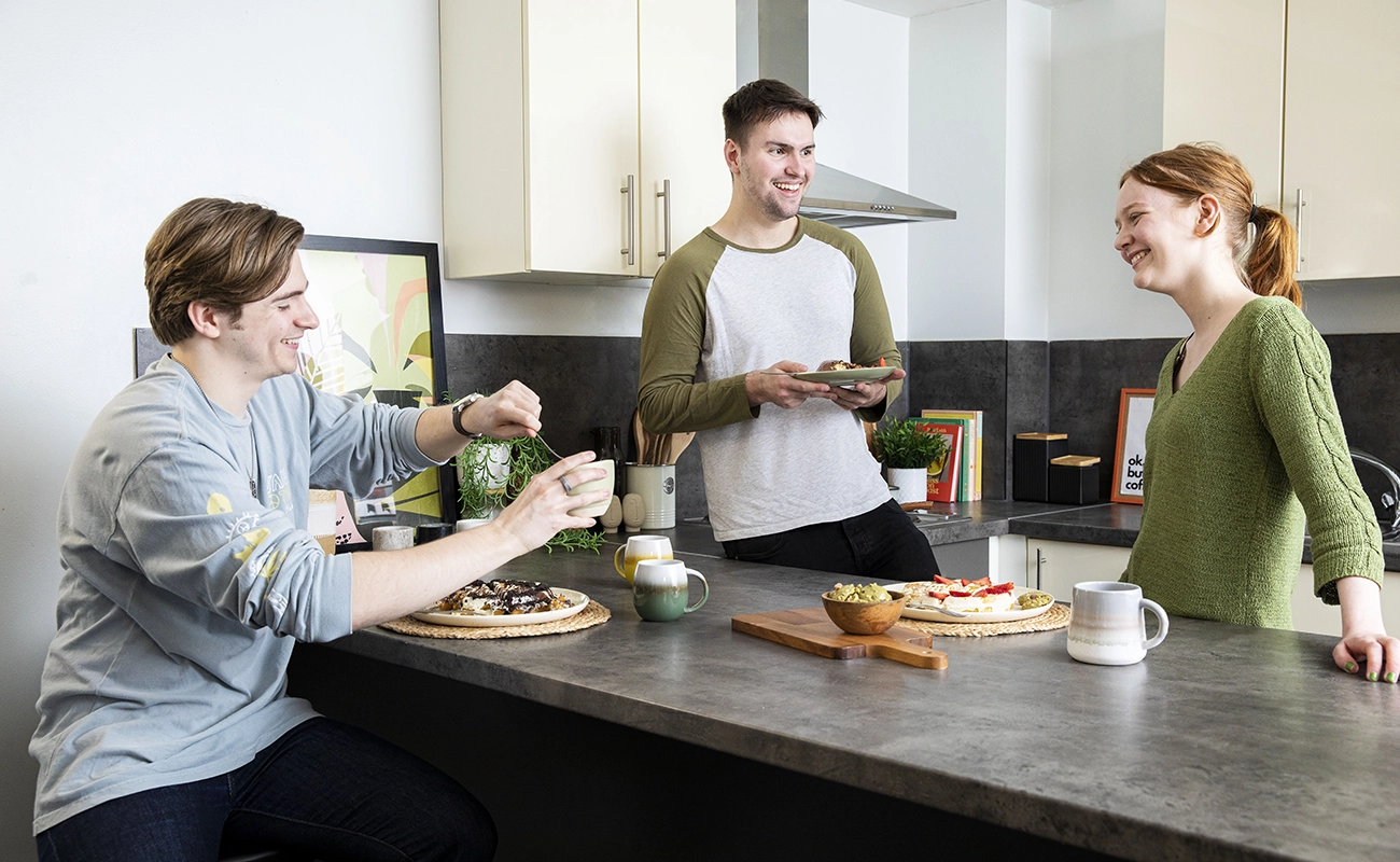 Students using the shared kitchen for ensuite rooms